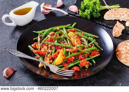 Fasolakia Lathera, Green Beans, Onion And Potatoes Stewed In Tomato, Herbs And Olive Oil Served On B