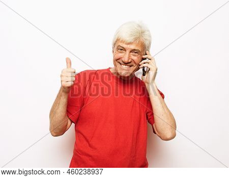Close Up Of Happy Old Man Using Smartphone Over White Background.