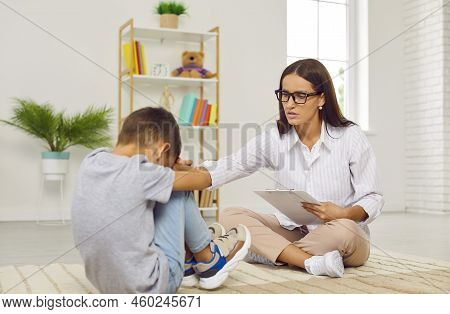 Therapist Or School Psychologist Trying To Help And Support Stressed Little Child