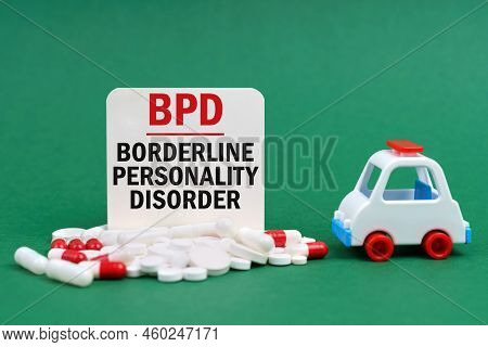 Medical Concept. On A Green Surface, An Ambulance, Pills And A White Sign With The Inscription - Bor