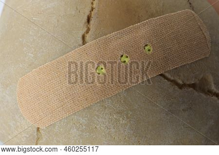 Beige Sticking Plaster On Human Skull, Closeup