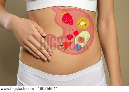 Woman With Image Of Stomach Full Of Food Drawn On Her Belly Against Beige Background, Closeup. Healt