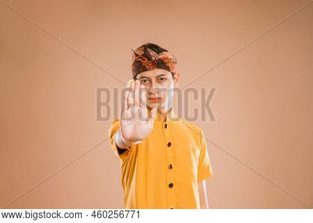 Balinese Young Man Showing Stop Gesture To Camera