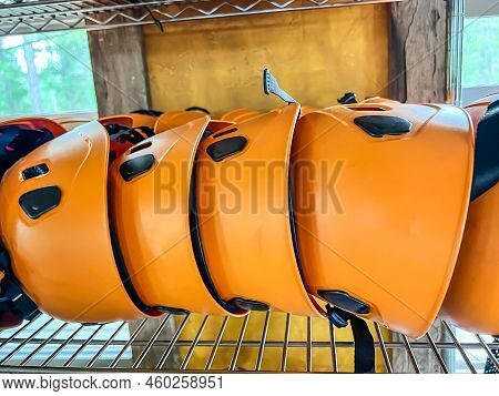 Row Of Helmets Ready For Use At A High Ropes And Climbing Course.