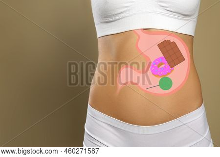 Woman With Image Of Stomach Full Of Junk Food Drawn On Her Belly Against Beige Background, Closeup. 