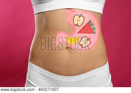 Woman With Image Of Stomach Full Of Food Drawn On Her Belly Against Pink Background, Closeup. Health