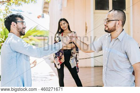 Two Teenage Friends Bumping Their Fists Outdoors. Concept Of Friends Bumping Fists Amicably, Two Ove