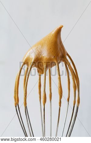 Close-up Of Metal Whisk With Whipped Coffee For Dalgona Coffee Drink Isolated On The White Backgroun