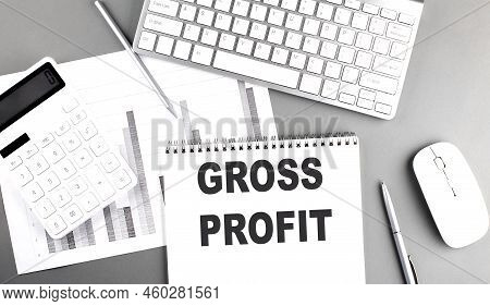 Gross Profit Text Written On Notebook On A Grey Background With Chart And Keyboard, Business Concept