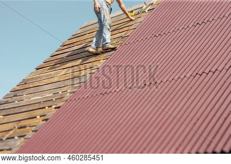 A Worker Standing On Unfinished Rooftop Without Safety Harness, Outdoor Shot