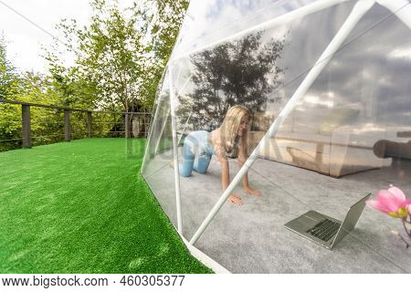 A Woman Is In A Geo Dome Glamping Tent. Glamping Vacation Lifestyle Concept.