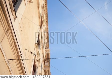 Electric Cables Running Between City Buildings Across