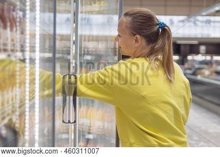 A Girl Of European Appearance With Blond Hair Tied In A Ponytail With A Blue Elastic Band In A Yello