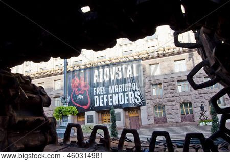 Kyiv, Ukraine - August 22, 2022: Azov And Azovstal Banner With Destroyed Russian Military Equipment.
