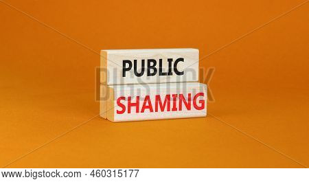 Public Shaming Symbol. Concept Words Public Shaming On Wooden Blocks On A Beautiful Orange Table Ora