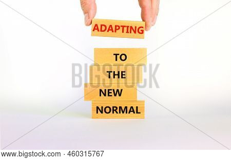 Adapting To The New Normal Symbol. Wooden Blocks With Words Adapting To The New Normal On Beautiful 