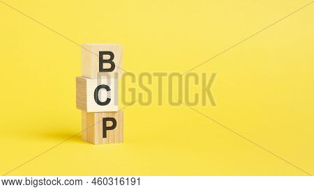 Bcp Text On Wooden Block With Yellow Backgrounds