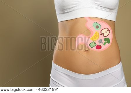 Woman With Image Of Stomach Full Of Food Drawn On Her Belly Against Beige Background, Closeup. Healt