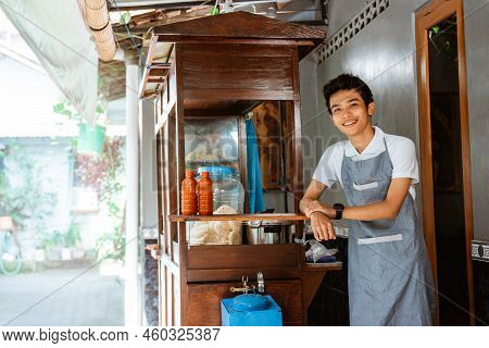 Smiling Male Chicken Noodle Seller Wearing Apron Standing