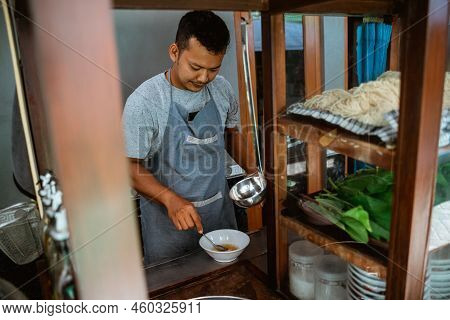 Man Seller Stir Vegetable Oil In The Bowl