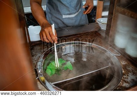 Close Up Of Mans Hand Boiled Vegetables When Prepare