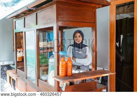 Muslim Woman Seller Wearing Apron Smiling With Crossed Hands
