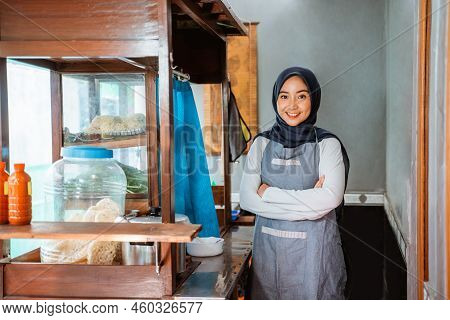 Hijab Woman Wearing Apron Smiling While Standing With Crossed Hands