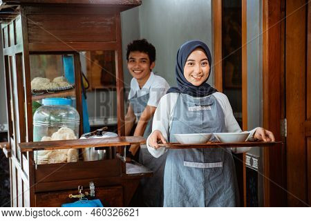 Female Muslim Seller Bringing Chicken Noodle Dish On Tray