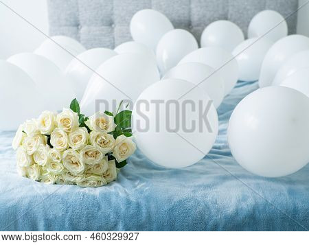 Beautiful Bouquet Of White Blooming Roses On The Bed. White Flowers With Lying On Blue Bed With Whit