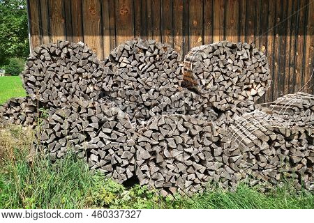 A Large Amount Of Firewood Under A Blue Sky