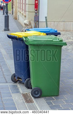 Sorting Waste Three Colour Coded Wheelie Bins At Street