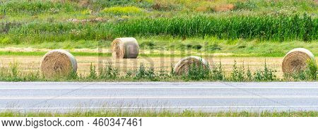 Dry Yellow Straw Bales Laying On The Farm Field At The Road