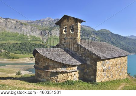 Chapel St. Magdelene By The Lake Of Roselend In A Mountainous Landscape French Alps