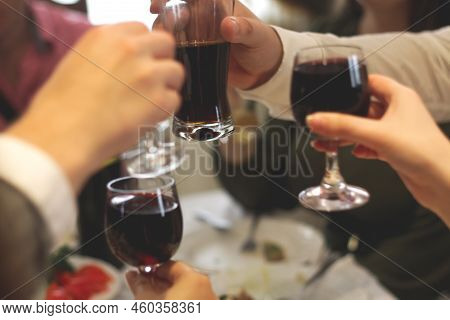 Defocus Toasting Glasses Background. Clinking Glasses With Alcohol And Toasting, Party. Company Of F