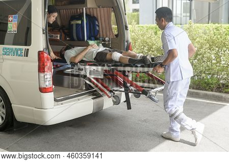 Group Of Rescue Emergency Team Transporting Patient From Emergency Car  Through Hospital Corridors.