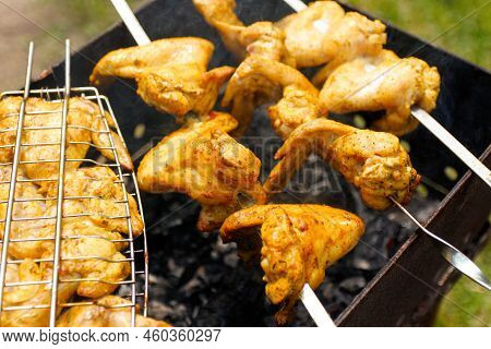 Defocus Delicious Chicken Wings Barbecue On Hot Grill. Chicken Legs And Wings Are Fried On Coals In 