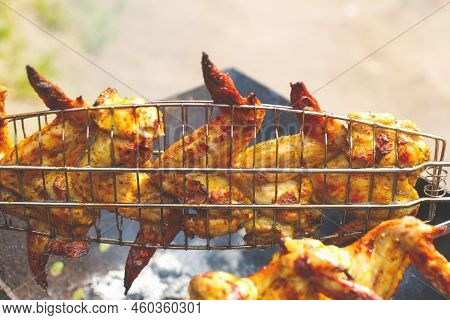 Defocus Delicious Chicken Wings Barbecue On Hot Grill. Chicken Legs And Wings Are Fried On Coals In 