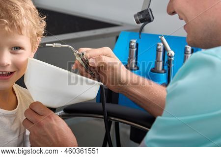 Close-up Of The Procedure Of Washing The Ears Of A Cheerful Boy In A Childrens Clinic. An Experience