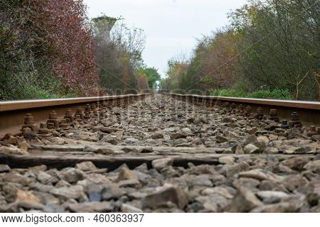 A View Of A Railway In The Autumn With Multi Colored Leaves