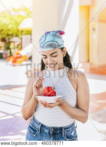 Young Woman Holding A Cup Of Shaved Ice On The Street. Concept Of A Girl With A Nicaraguan Raspado.