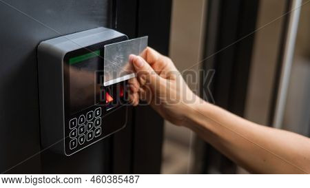 A Woman Opens The Door With A Plastic Card. Modern Keyless Entry Lock.