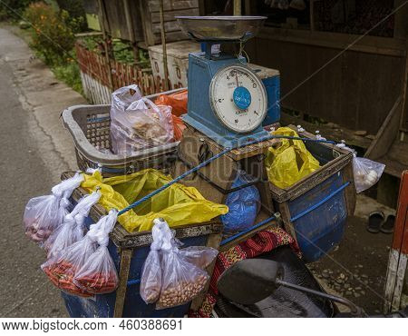 Indonesia, June 13 2022 - Motorcycles Are Loaded Down With Goods To Sell When Driven Door-to-door In