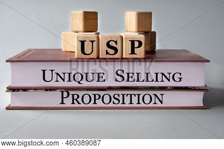 Usp (unique Selling Proposition) - Acronym On Wooden Cubes On The Background Of Recumbent Books. Bus