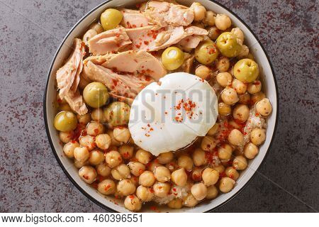 Chickpeas In Broth Served With Canned Tuna, Olives And Poached Egg Close-up In A Bowl On The Table. 