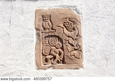 Hochheim, Germany - April 25, 2021: Sandstone Signet Of A Winery With Owl And Vine Leaf In The Rhein