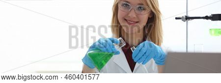 Scientist Holds Bottle With Sample With Toxic Green Liquid In Hands In Protective Gloves. Toxic Subs