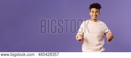 Portrait Of Cheerful, Happy Young 25s Man Recommending Product, Showing Promo Of Product, Delivery S