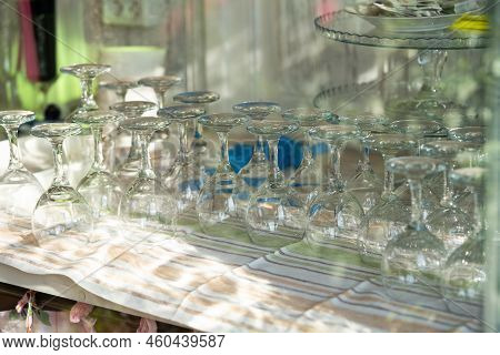 Transparent Shiny Goblets Get Dry After Washing Illuminated By Bright Sunlight On Sunny Day. Crystal