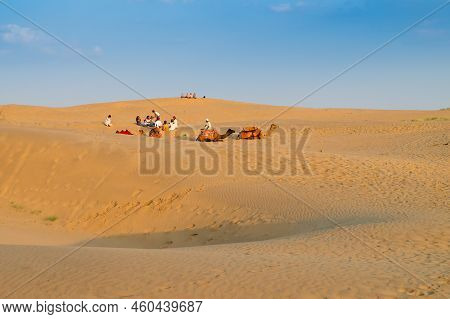 Tourists With Camels, Camelus Dromedarius, At Sand Dunes Of Thar Desert, Rajasthan, India. Camel Rid