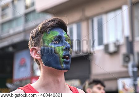 Buenos Aires, Argentina; August 25, 2022: Young Man With Planet Earth Painted On His Face Shouting A